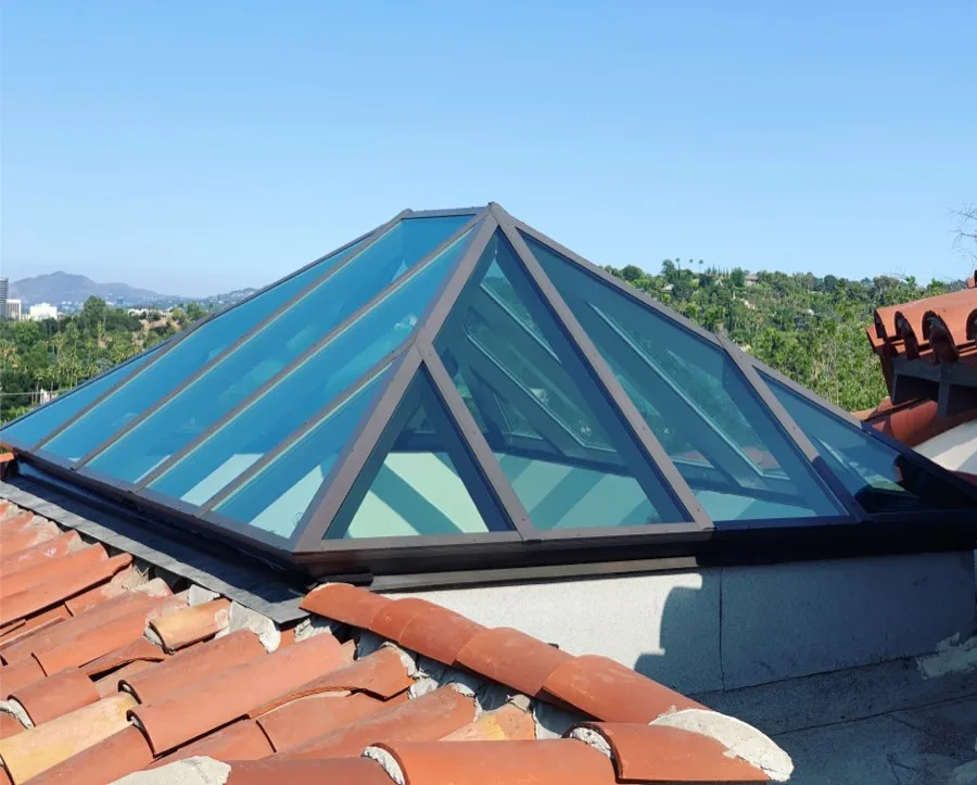 Custom pyramid skylight on a clay tile hillside roof in Glendale